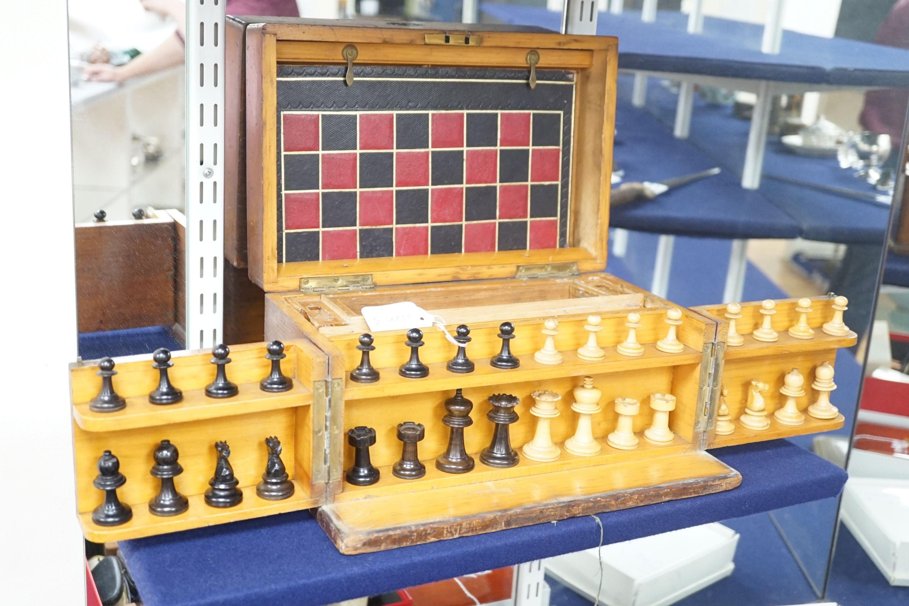 A 19th century mahogany games compendium with turned wood chess pieces and lead jockey and horse pieces